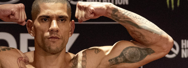 MMA fighter Alex Pereira flexes his muscles at the weigh-in before a UFC fight