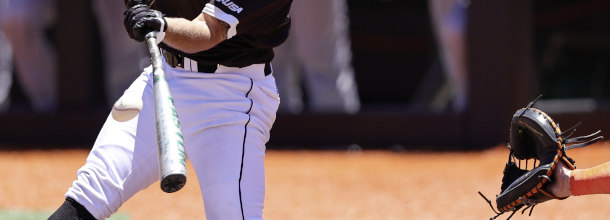 A College Baseball batter swings for a pitch in an NCAAB game