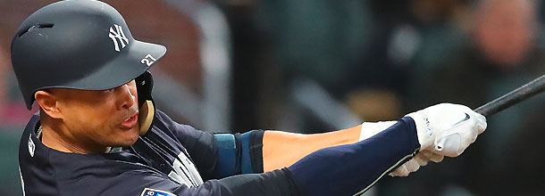 New York Yankees baseball star Giancarlo Stanton hits a home run in an MLB game