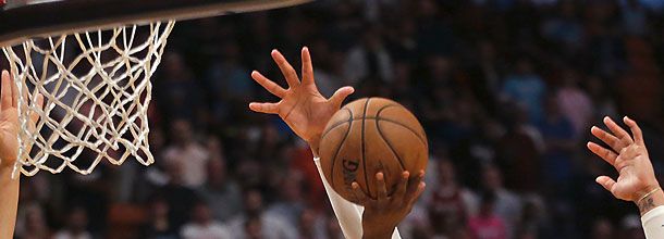 NBA players jumping to the basket during a basketball game