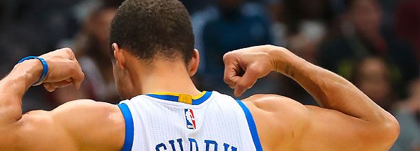Basketball star Stephen Curry flexes his muscles in an NBA game