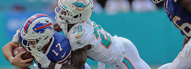 Players from the Buffalo Bills and the Miami Dolphins battle for the ball in an NFL game