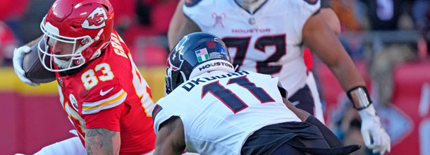 NFL players from the Kansas City Chiefs and the Houston Texans battle for the ball in a football game