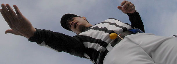 An NFL referee catches the coin after the coin toss
