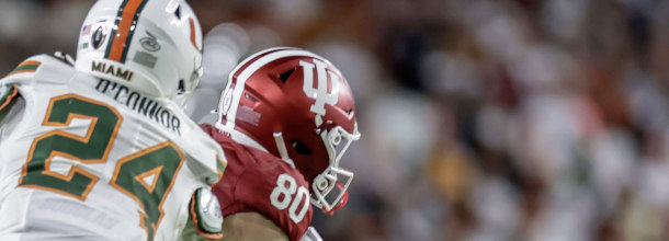Players from the Indiana Hoosiers and the Miami Hurricanes in action in the NCAAF