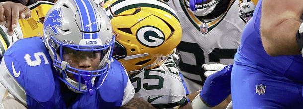 Football players from the Green Bay Packers and Detroit Lions in action in an NFL game