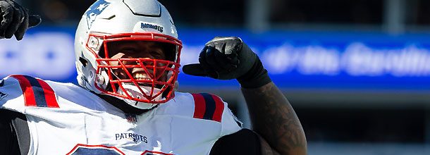 New England Patriots DT Davon Godchaux flexes his muscles after a sack in an NFL game