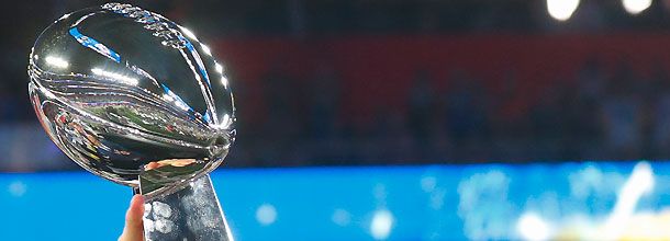 The Super Bowl trophy is held aloft after the NFL Championship Game