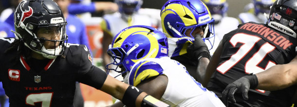 Football players from the Houston Texans and Los Angeles Rams in action in an NFL game