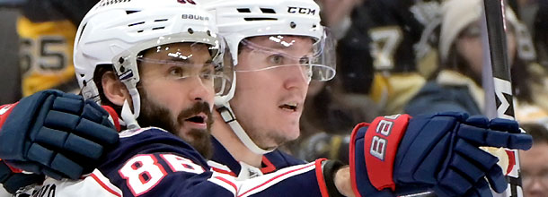Columbus Blue Jackets ice hockey players celebrate a goal in an NHL game