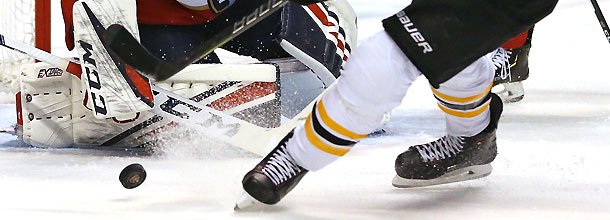 Ice hockey players battle for the puck in an NHL game