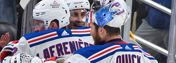 New York Rangers ice hockey players celebrate a goal in an NHL game
