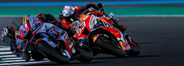 MotoGP riders battle for position during a Grand Prix