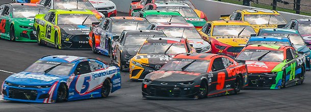 NASCAR cars race round the track in a Cup Series race