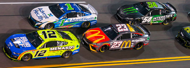 NASCAR cars race round the track in a Cup Series race