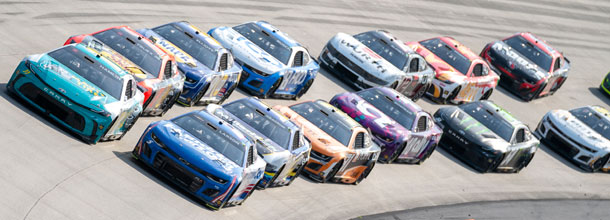 NASCAR cars race round the track in a Cup Series race