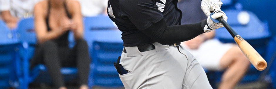 An MLB baseball player hits a pitch