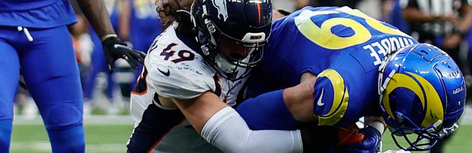 Players from the Denver Broncos and the Los Angeles Rams battle for the ball in the NFL
