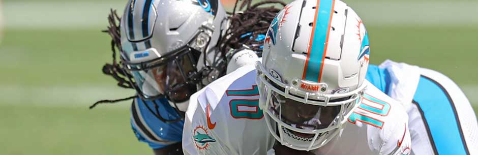 Players from the Miami Dolphins and the Carolina Panthers battle for the ball in the NFL