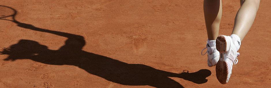 A tennis player seen as a shadow at the French Open Grand Slam tournament