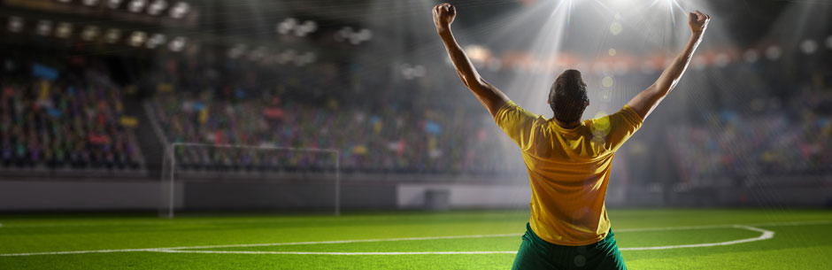 A soccer player celebrates scoring a goal