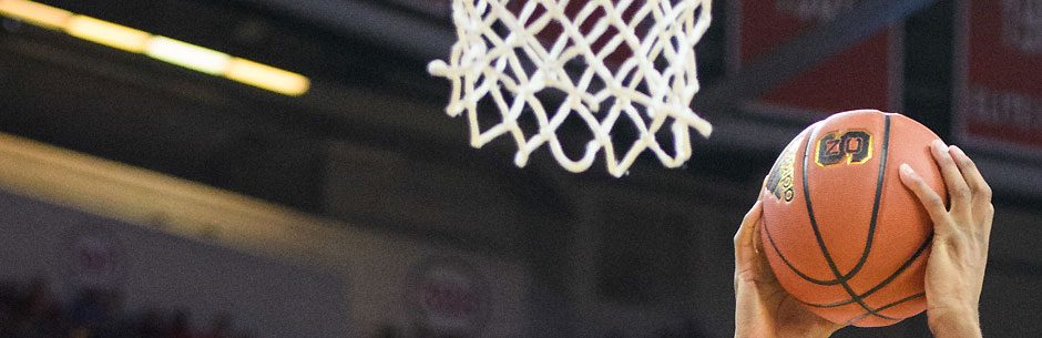 A College Hoops player lays up to the basket at the March Madness tourney