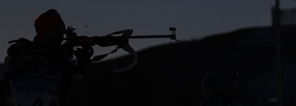A biathlete takes aim at the shooting stand at the Beijing Olympic Games