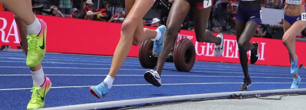 Athletes run around the track at an international track and field meet