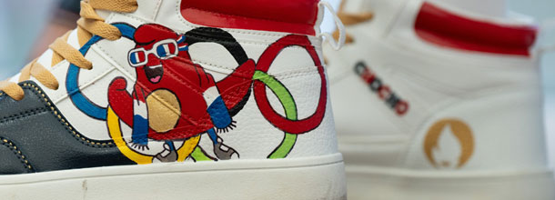 A sports training shoe depsicting the Olympic rings and the Paris 2024 mascot