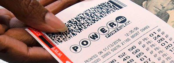 A hand passes over a powerball lottery ticket