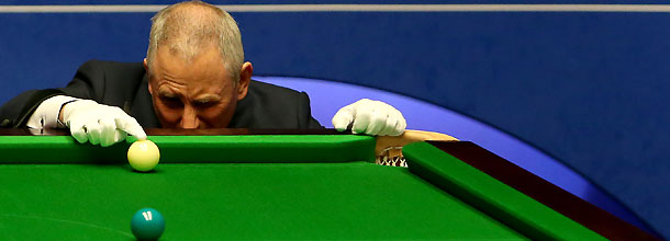 A snooker referee spots the ball on the table at the World Championships in Sheffield