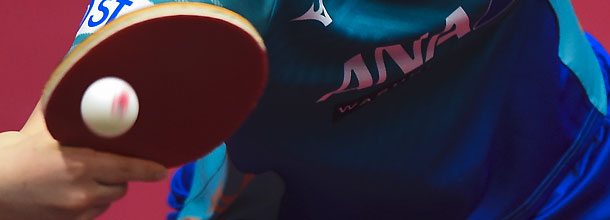 A pro table-tennis player hits a shot