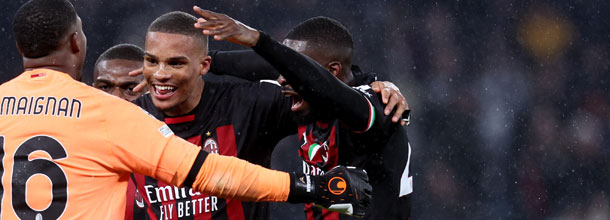 Soccer players from AC Milan celebrate a victory in the UEFA Champions League