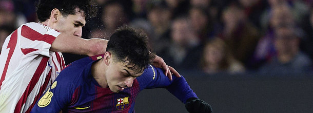 Soccer players from Atletico Madrid and Barcelona in action in a UEFA Champions League game