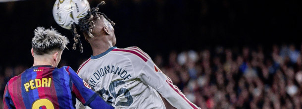 Soccer players from Real Madrid and Barcelona battle for the ball in a LaLiga duel