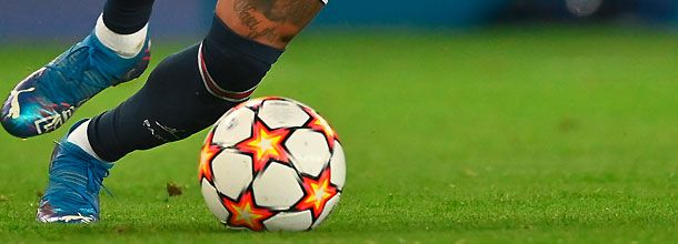 A soccer player seen dribbling the ball in the Uefa Champions League