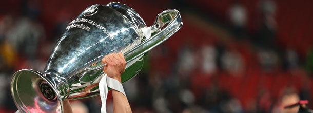 A soccer player holds the UEFA Champions League aloft