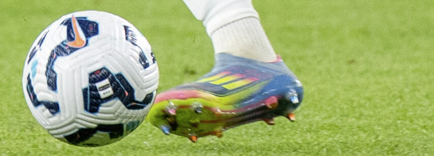 A soccer ball and the foot of a player