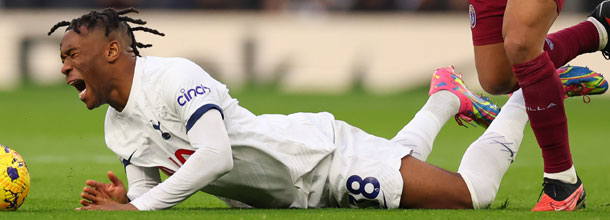 Tottenham soccer star Udogie shouts in pain after a foul in the English Premier League