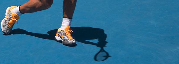 A tennis player hits a shot at the Australian Open tennis Grand Slam