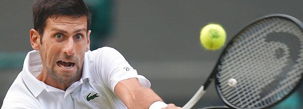 Serbian tennis star Novak Djokovic hits a shot at the Wimbledon Grand Slam tournament