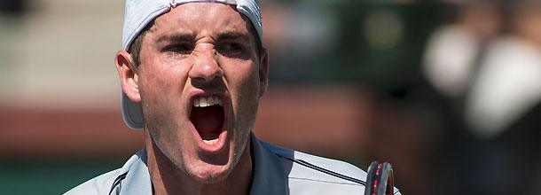 Tennis star John Isner celebrates a win on the grass at Wimbledon