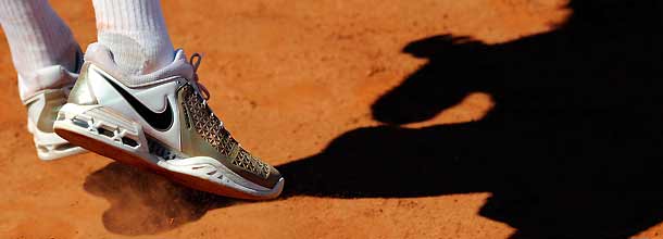 A tennis player's feet on a clay court on the ATP Tour