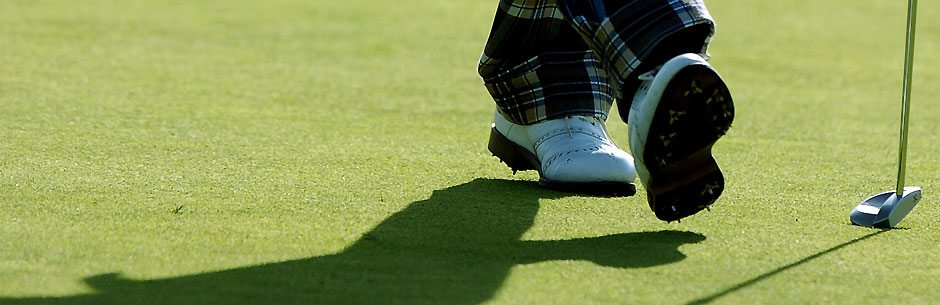 A golf player strides across the green during a PGA Tour tournament